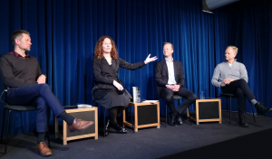 Three men and one woman are in a discussion on a stage, sitting, one of which is Camilla Stoltenberg, who is engaged with her arm in a gesture. The other people are Espen Solberg (NIFU), Leif Rune Skymoen (LMI) and Ole Alexander Opdalshei (Norwegian Cancer Society).